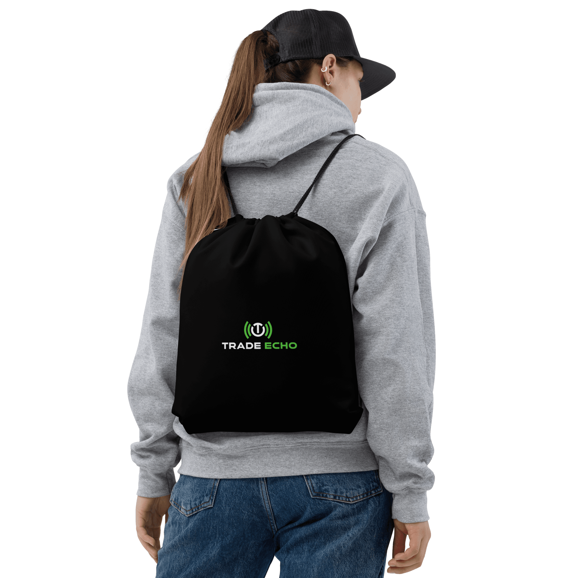 Black Trade Echo drawstring bag worn as a backpack over a gray hoodie, with the logo facing outward.