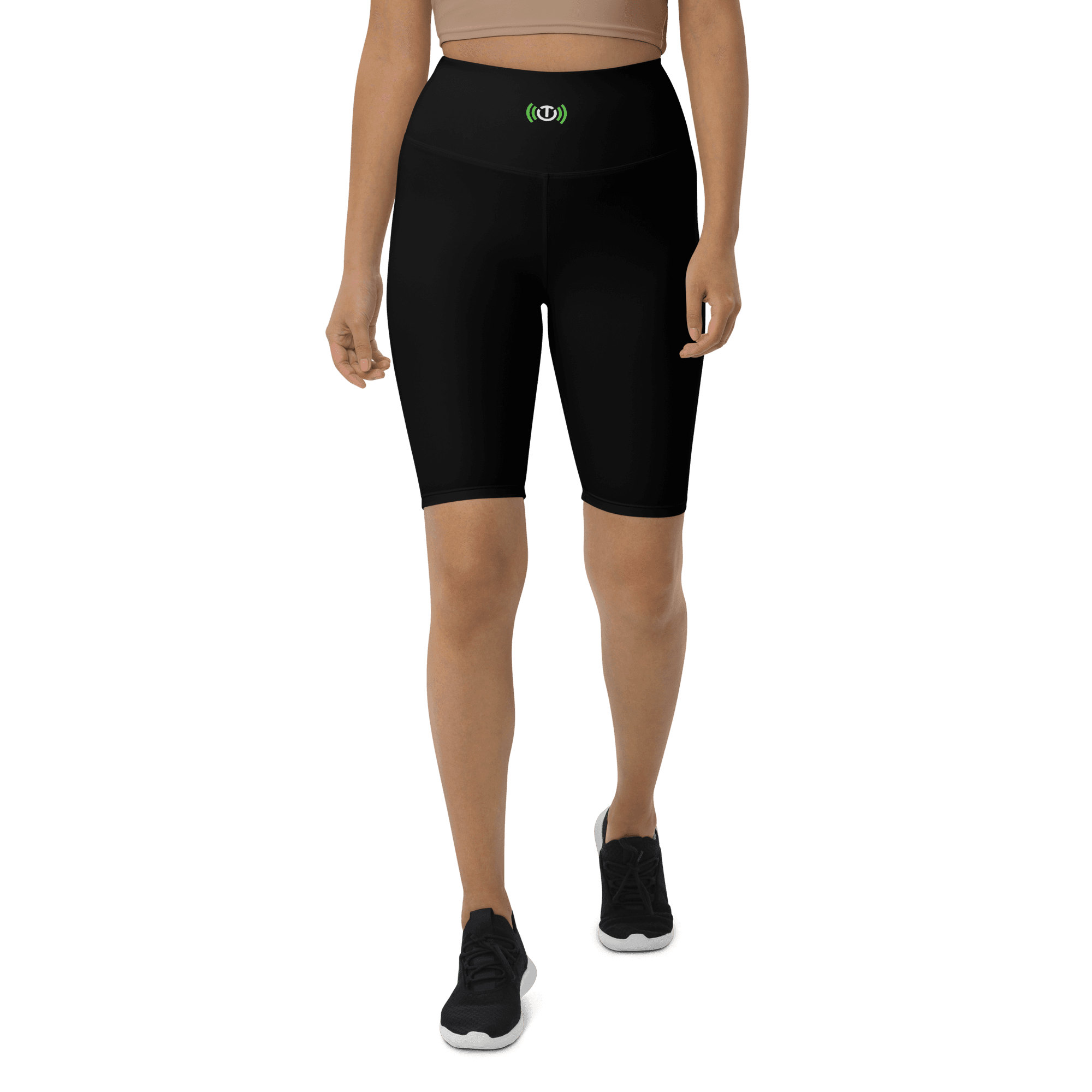 Second model wearing black biker shorts from the front, with the centered waistband TE icon visible.